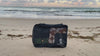Ocean waves crashing on beach in the background and a vacuum compression cube in the foreground
